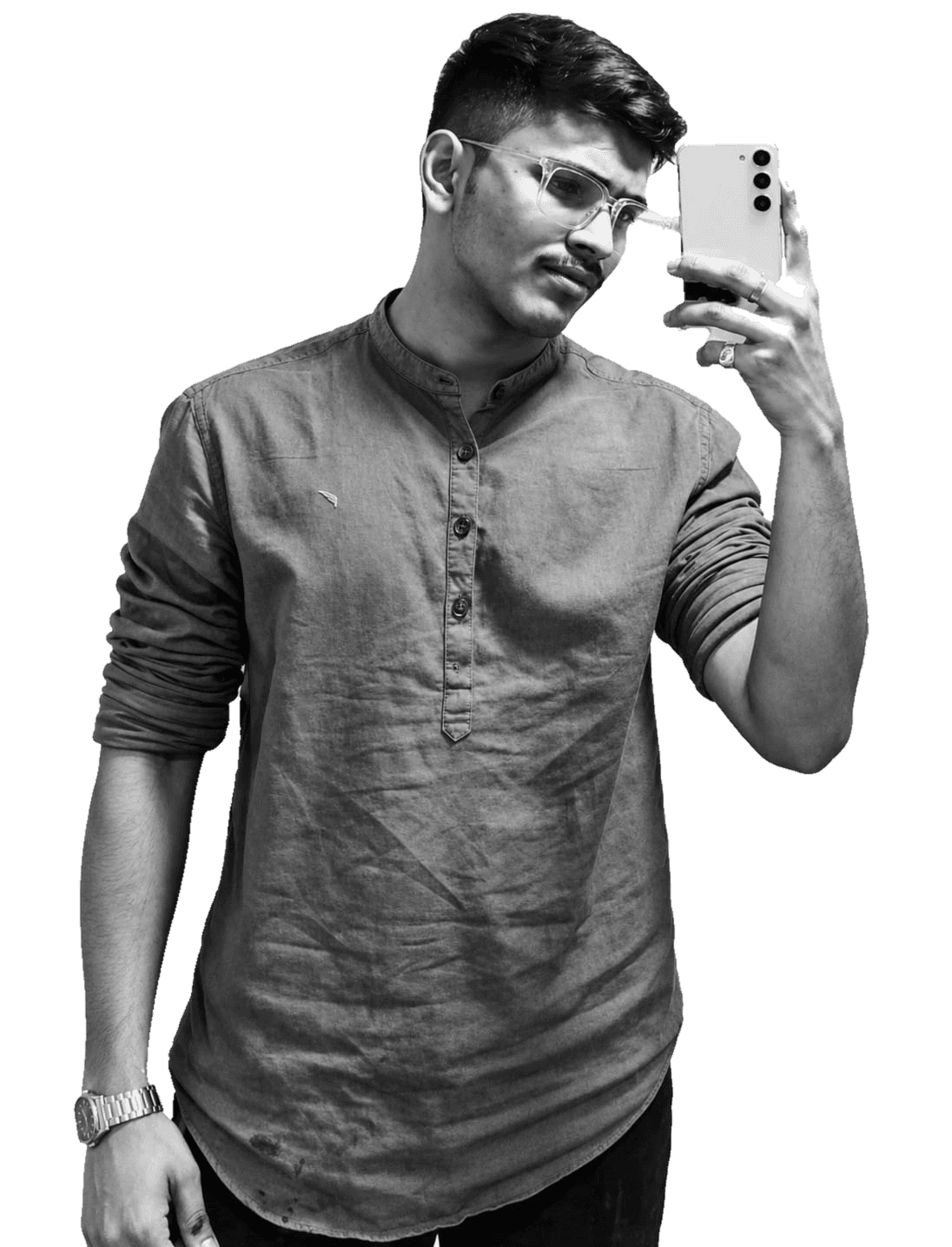 Black-and-white portrait of Aditya Jadhav in glasses and a band-collar shirt, taking a mirror selfie